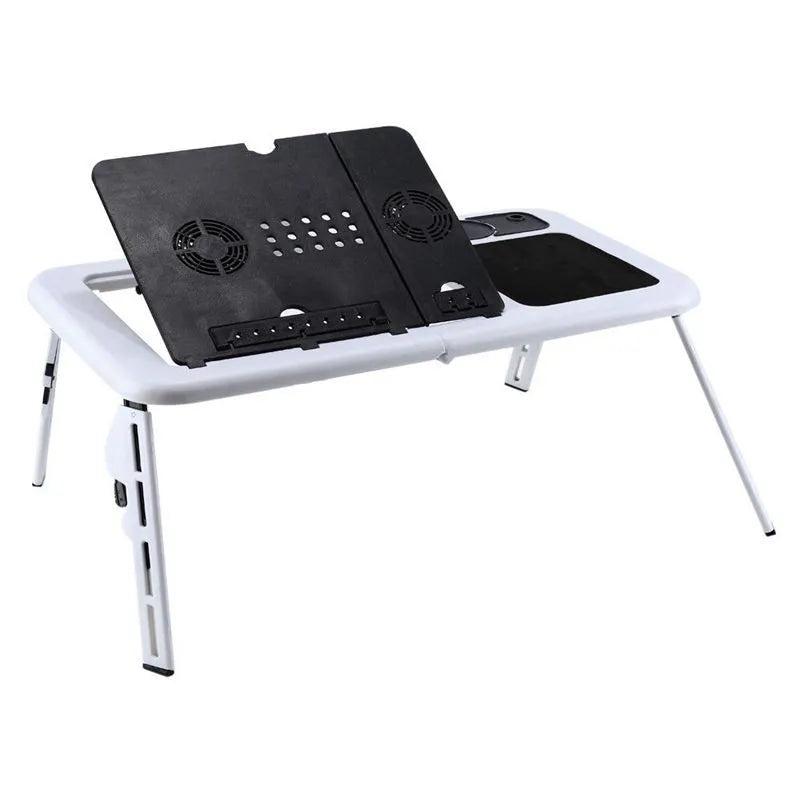 White folding computer desk bed with adjustable legs and tilting baseplate, open on a bed showing dual heat vents