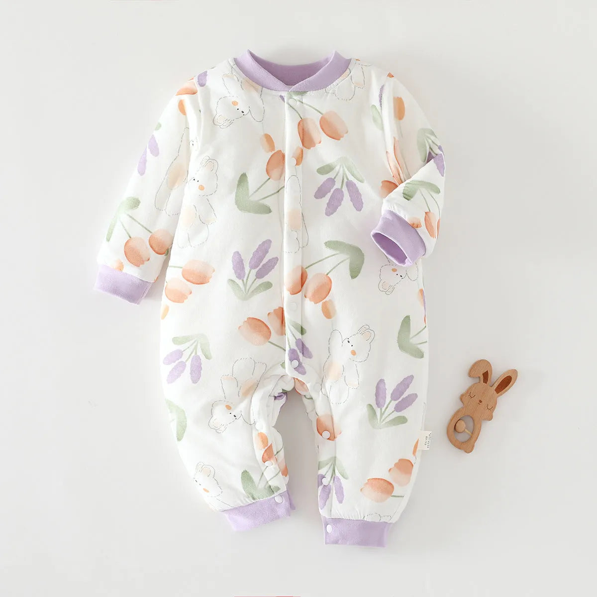 Infant one-piece romper in cotton with closed crotch, long sleeves, and animal-themed colours.