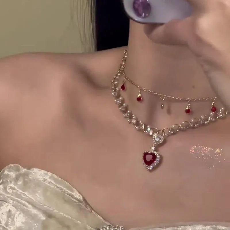 Red alloy double layer necklace with a love heart pendant on a regular chain.