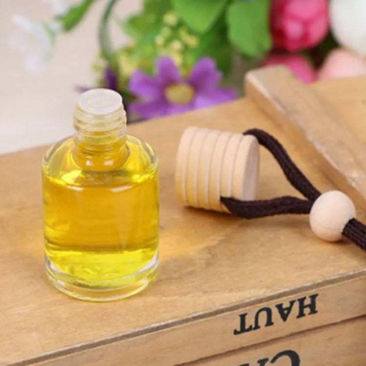 Car air freshener glass bottle hanging ornament showing scent options: Lavender, Lemon, Apple, Strawberry, Ocean, Floral.