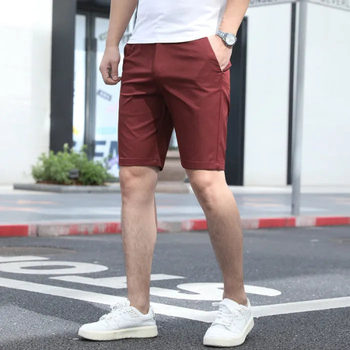 Man wearing loose-fit, mid-length casual trousers with an elastic waist in a solid colour.