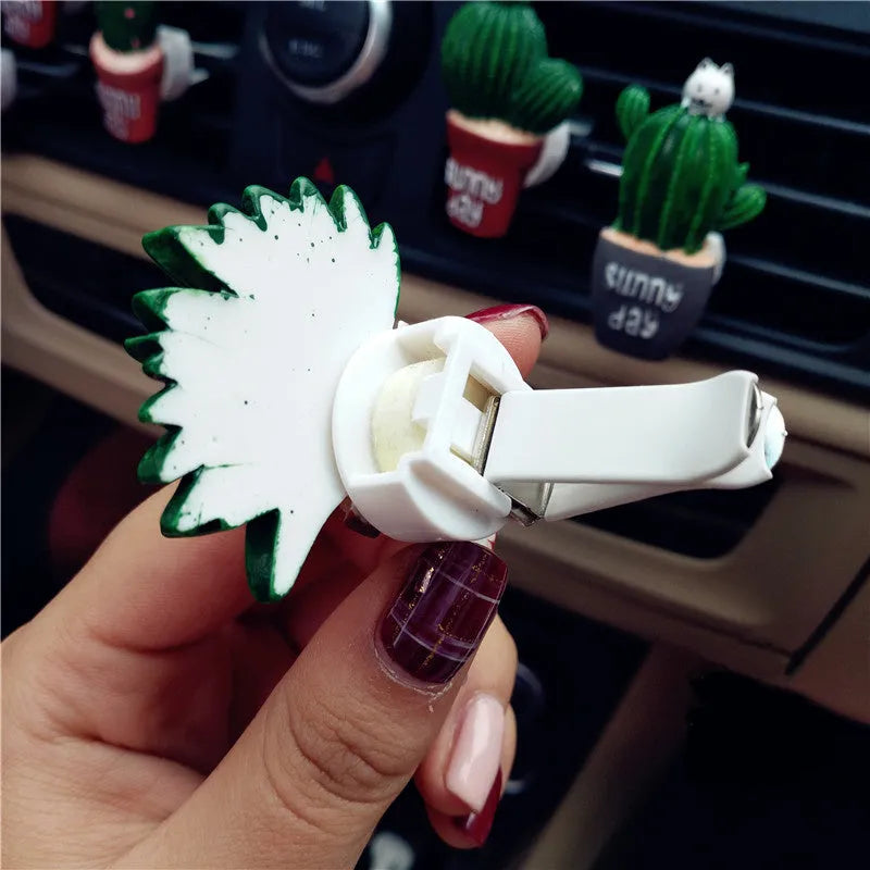 Cute green cactus car air freshener vent clip attached to car air conditioning vent