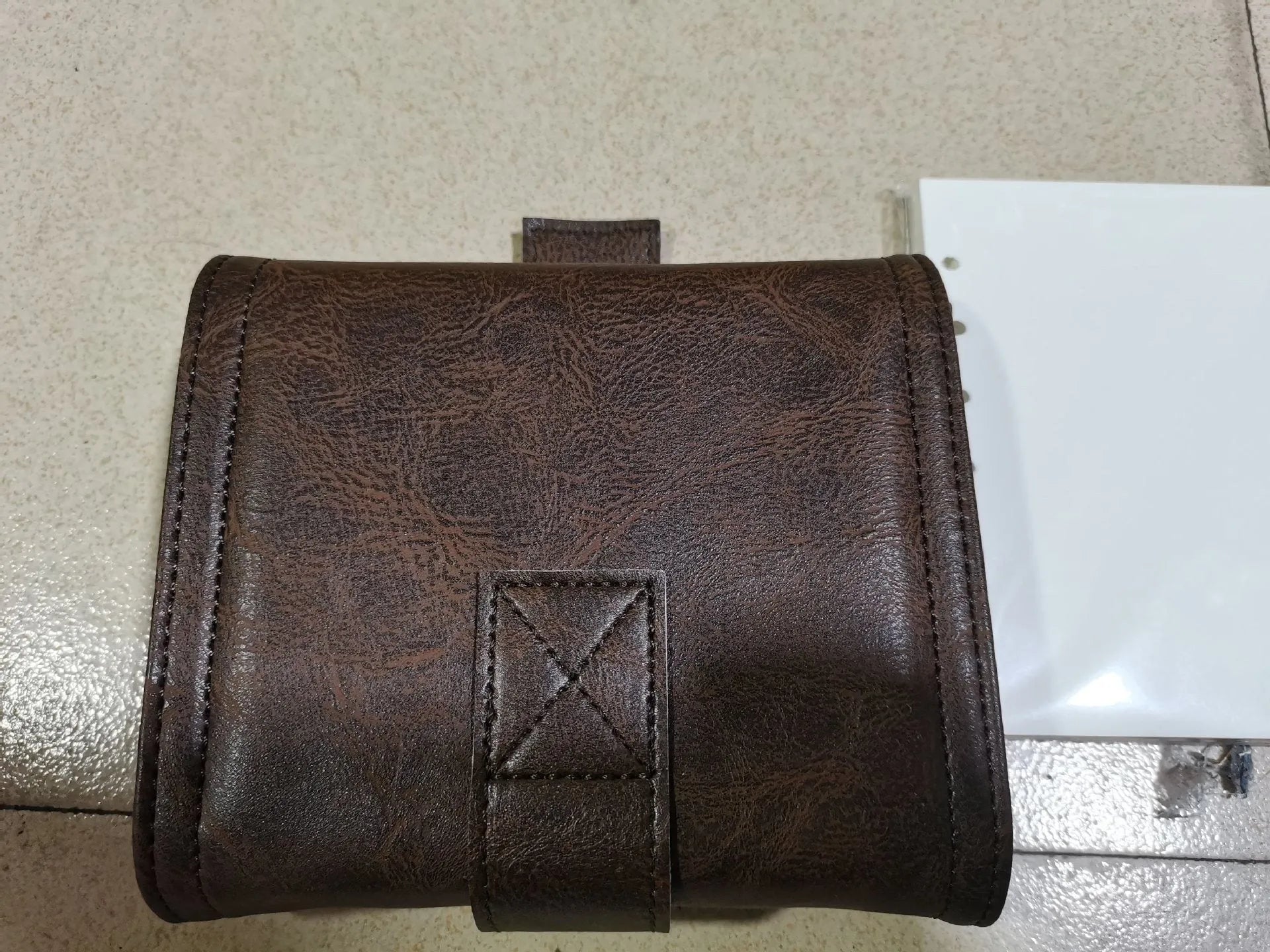 Brown retro-style A7 notebook with a PU cover and leather buckle, shown open to reveal loose-leaf binding.