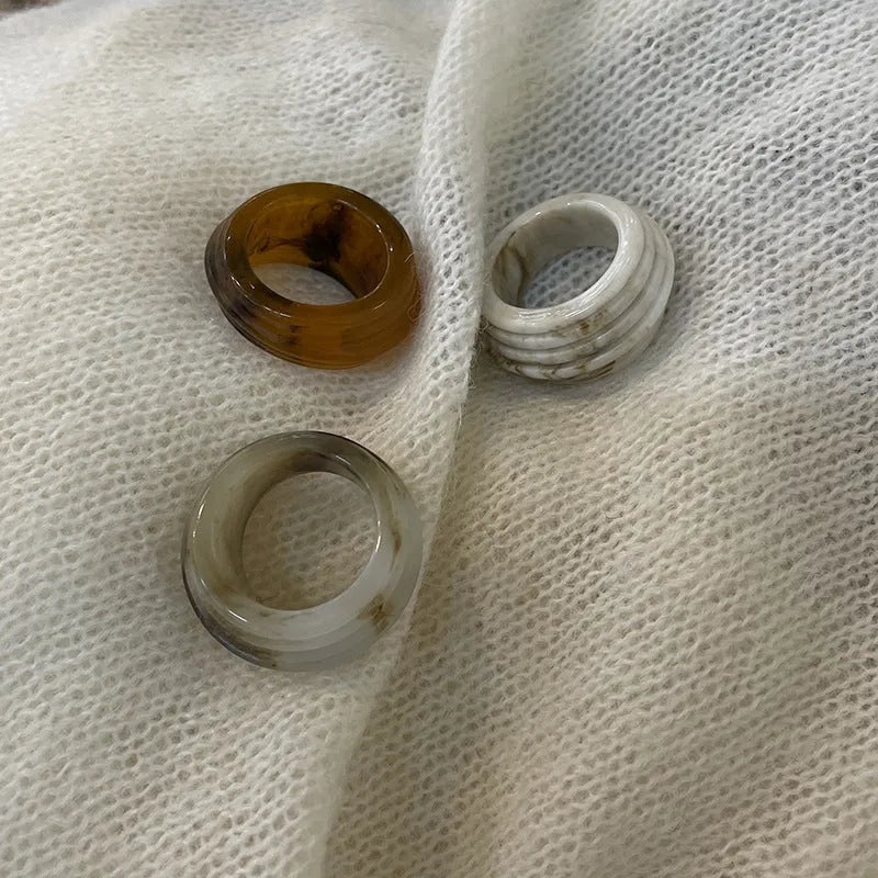 Geometric resin wide ring with irregular Chinese-inspired design in brown and white colours