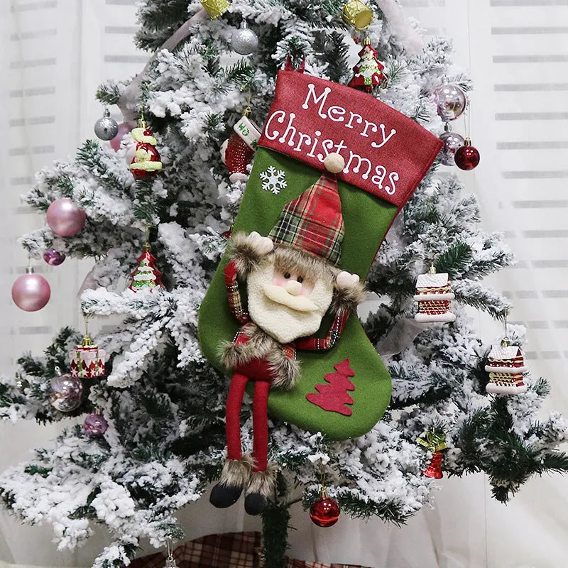 Three large Christmas stockings with Santa Snowman Reindeer 3D plush designs for holiday tree decoration