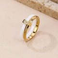 Women's heart-shaped titanium steel ring with glossy stitching and zirconium detail in gold black, golden white, and steel white.
