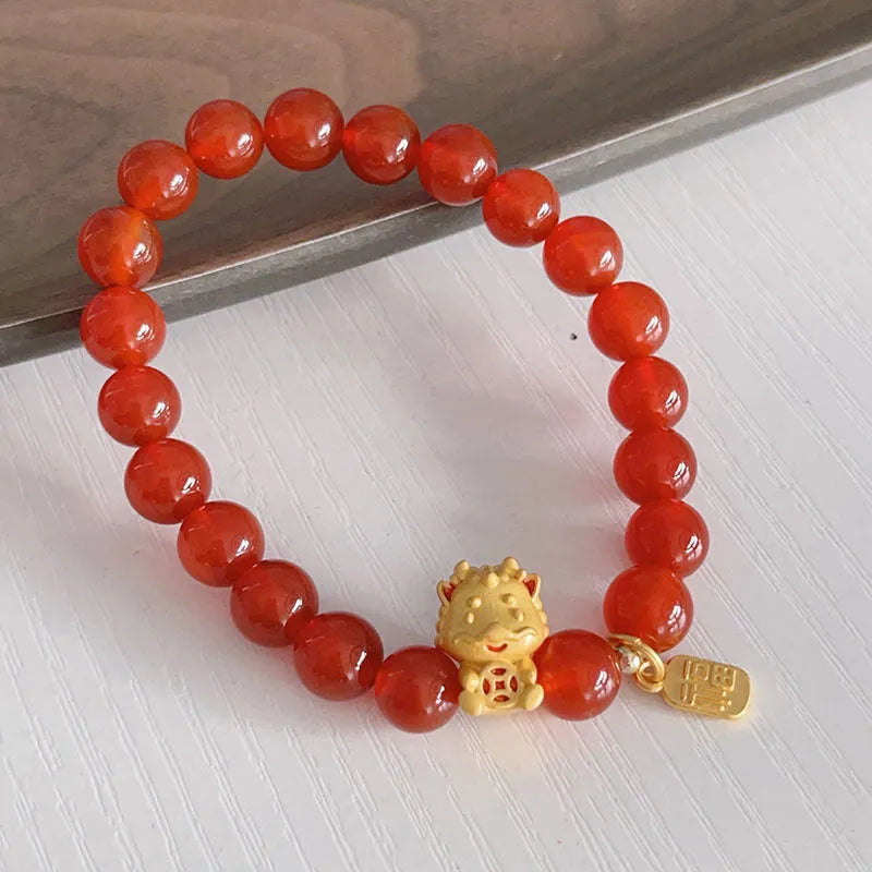 Close-up of a handmade red agate bracelet for women with a traditional Chinese dragon design.