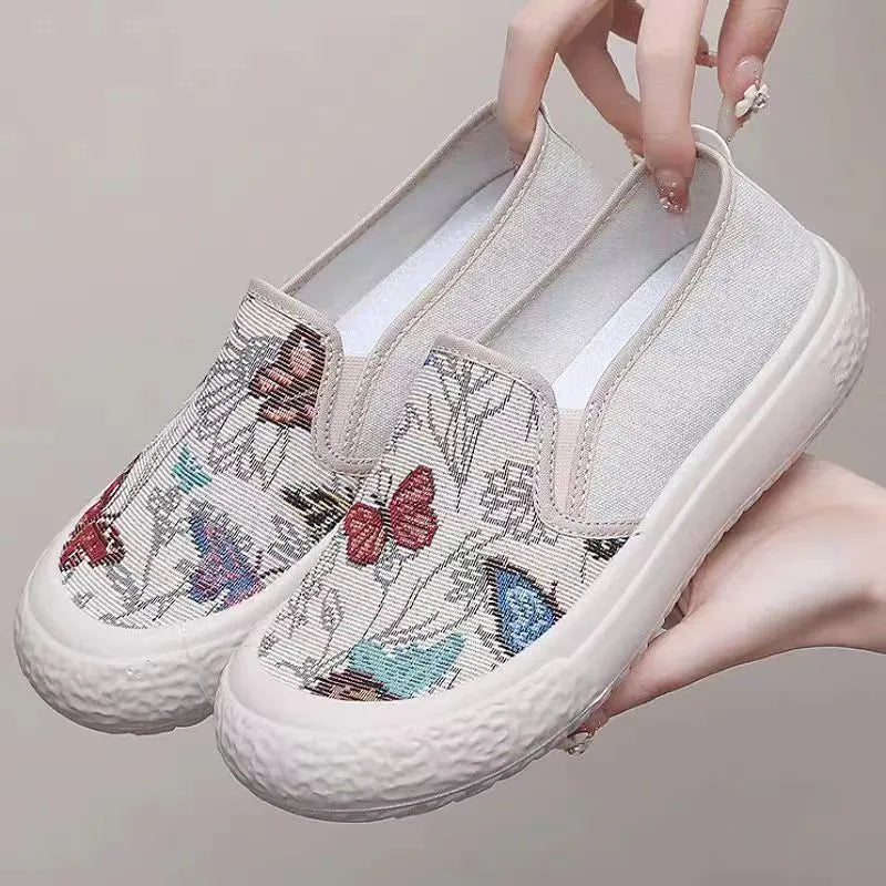Women's black and white slip-on canvas shoes with round toes and plastic soles