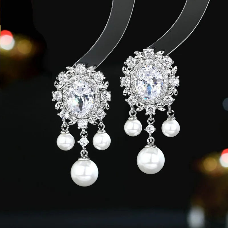 Copper oval earrings with zircon inlay and pearl tassels in light purple colour