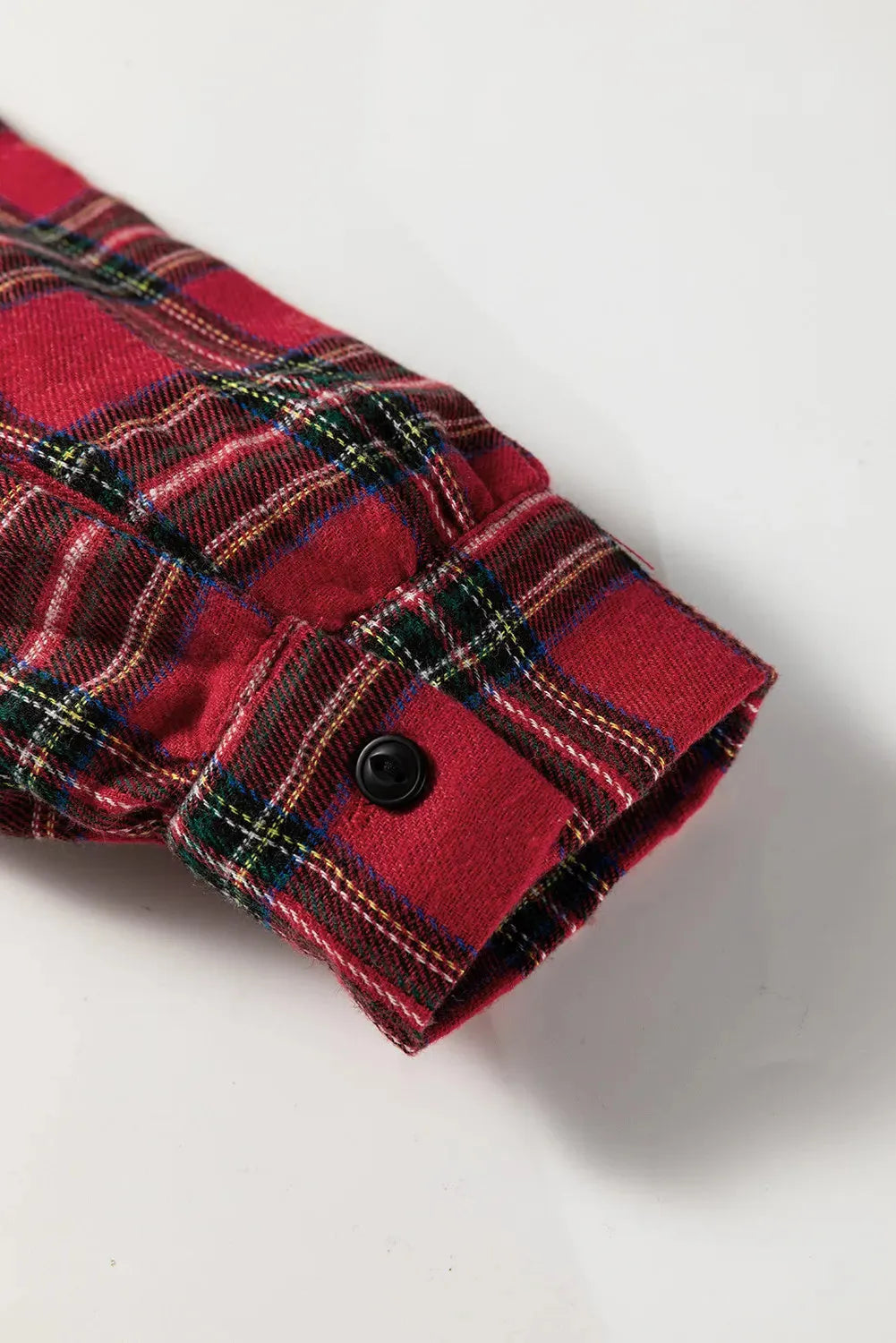 Red plaid patterned women's mini dress with a shirt collar, long sleeves, half-button front, and a ruffle hem.