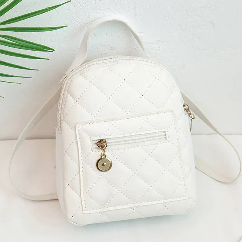 Girls' hard-case embroidered backpack in pink, showing front design and shoulder straps.