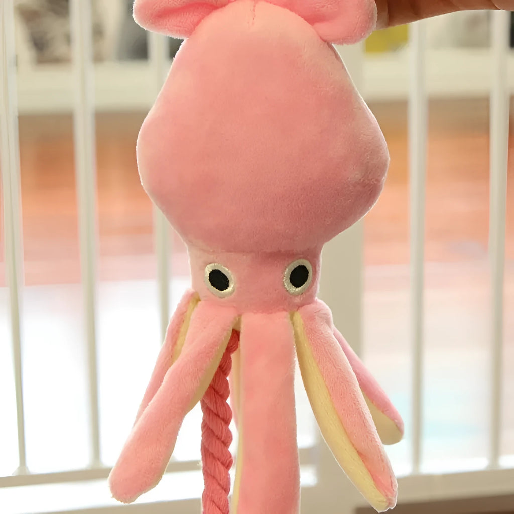 Pink octopus pet plush toy rope toy for dogs with soft fabric head and rope body on white background