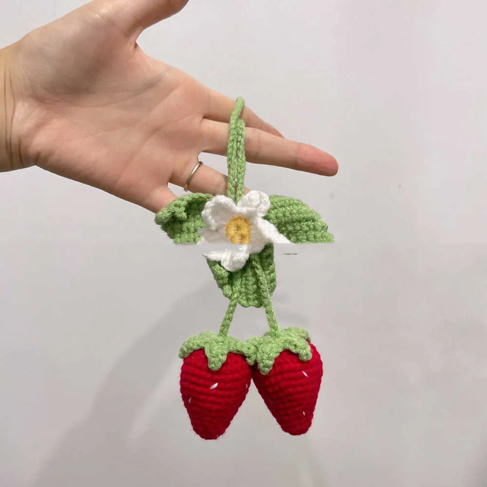 Handmade strawberry-shaped car pendant knitted from cotton and hemp wool.