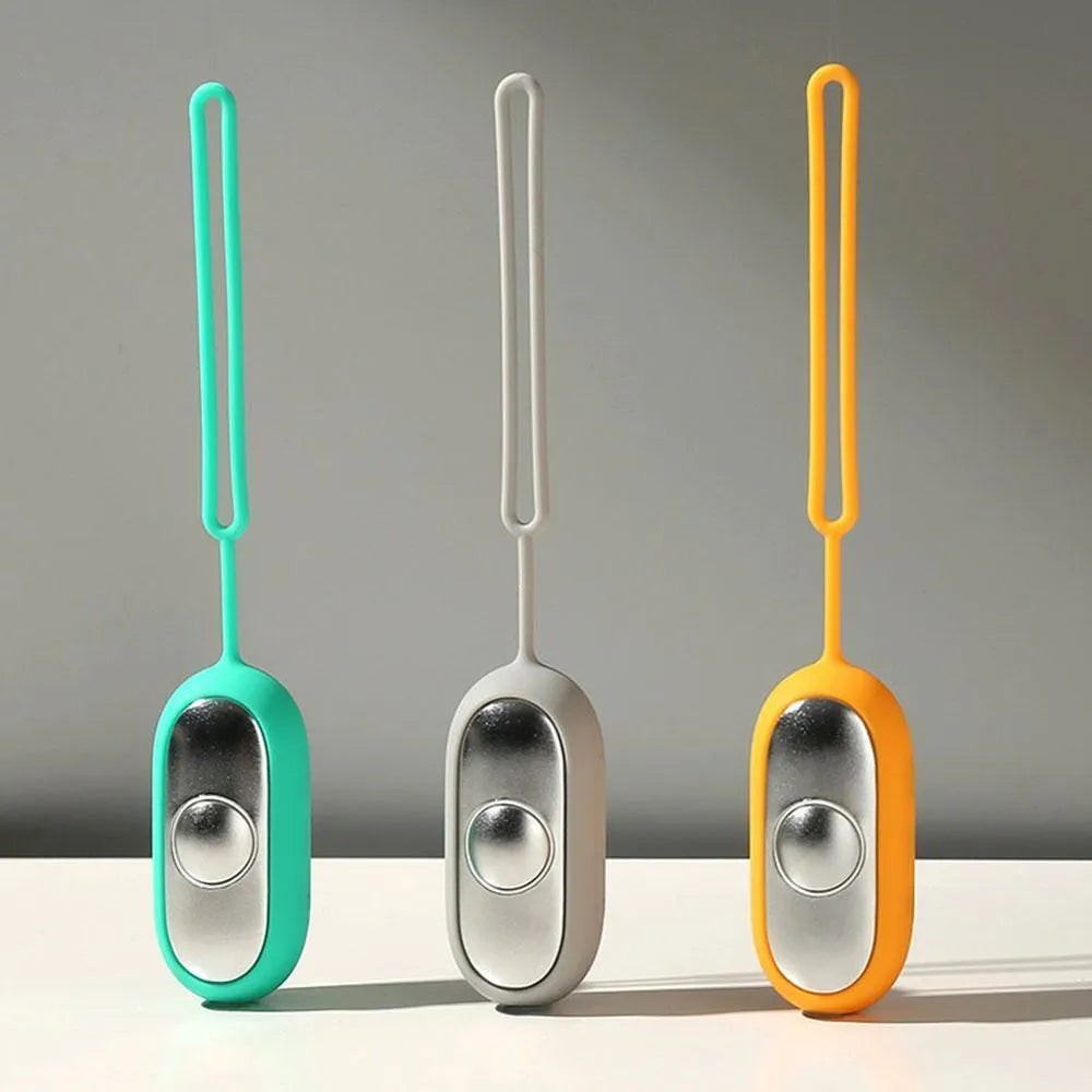 Handheld microcurrent sleep aid device with round button, USB charging port, and stainless steel electrodes in grey green orange colours