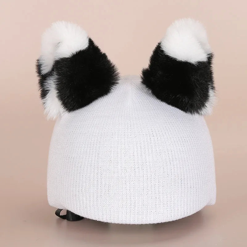 Soft plush cartoon character hat topper decoration for a ski helmet.