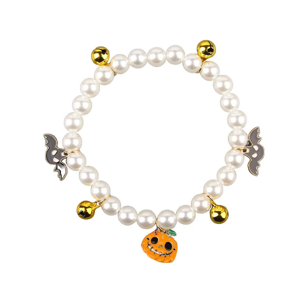 Halloween decorative pet collar with simulated pearls and a choice of pumpkin-themed charms: purple ghost, skull, or smiling.