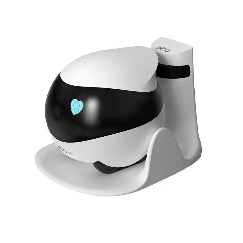 White smart home mobile surveillance robot camera with front sensors on a docking station.