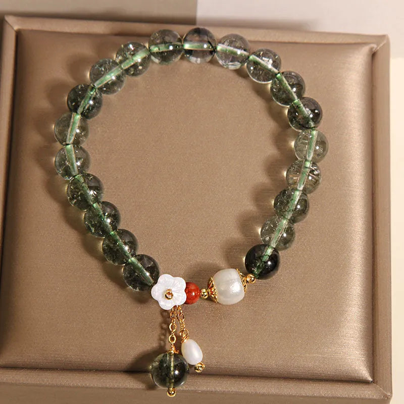 Green phantom quartz crystal bracelet with Bells of Ireland and shell flower design