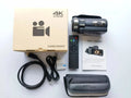 Black WIFI digital HD night vision camera with 3-inch screen showing menu, beside its included lens cover and remote control.