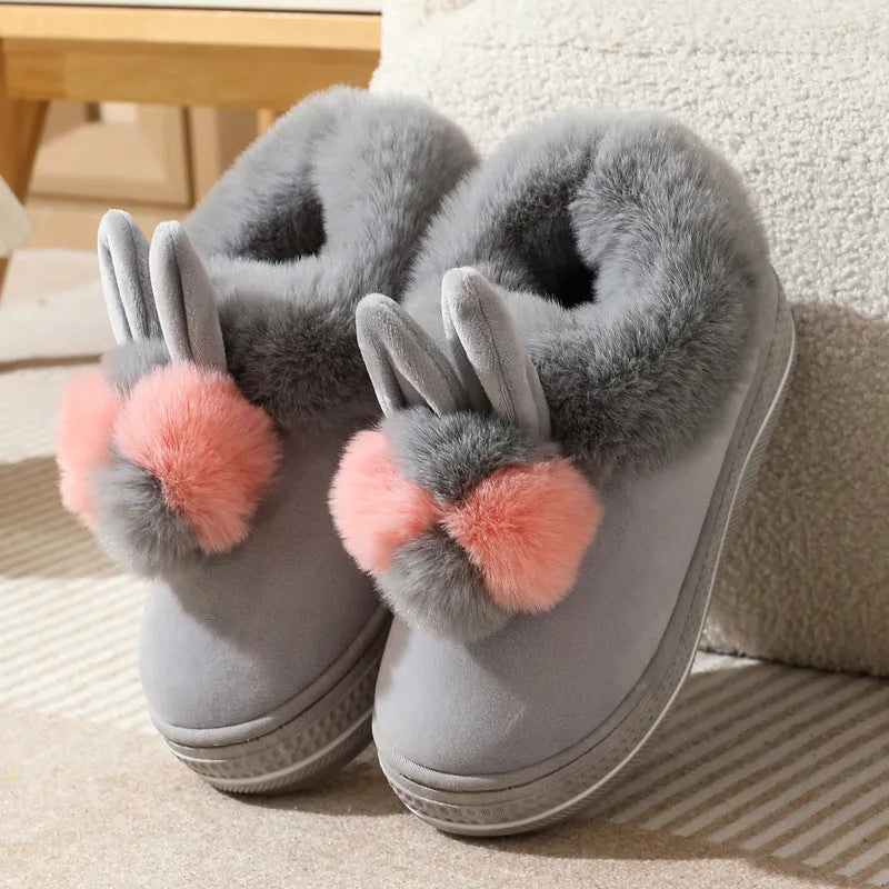 A pair of thick-soled high heel slippers in plush material with a TPR sole, shown in grey colour.