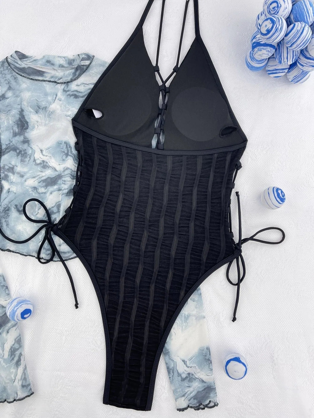 Black solid colour one-piece swimsuit with bikini styling on mannequin