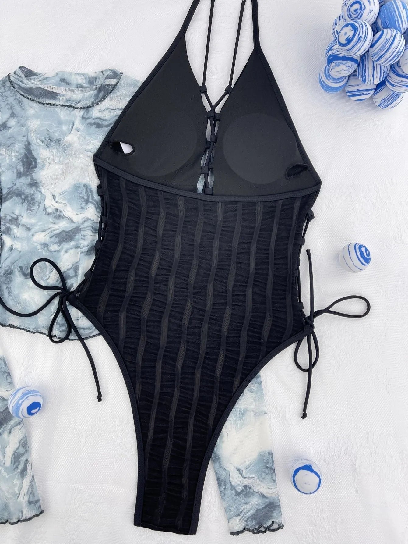Black solid colour one-piece swimsuit with bikini styling on mannequin