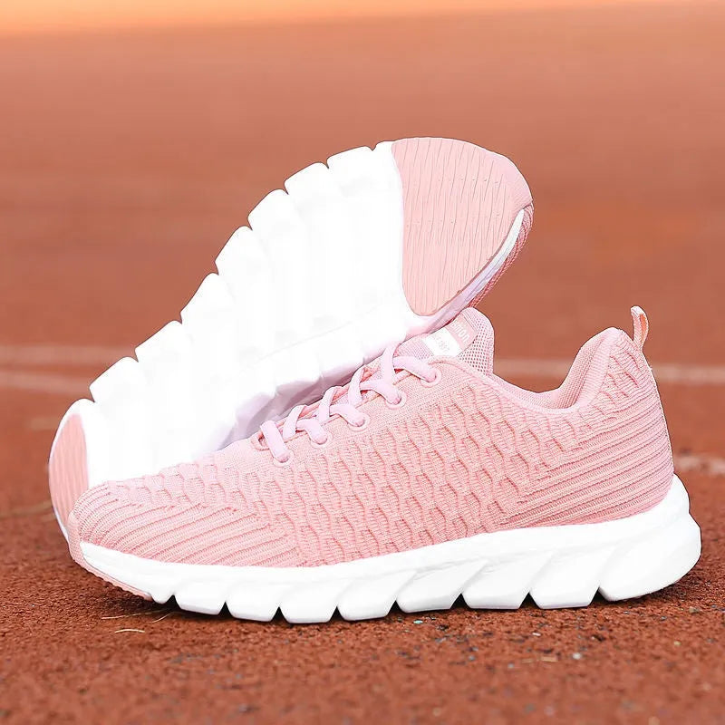 Women's running shoes with fly weave upper in black, pink or white on wear-resistant outsole.