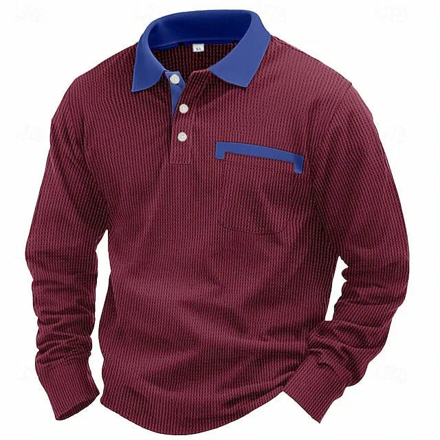 Man wearing a long-sleeved waffle knit polo shirt with an asymmetric collar in a dark colour.