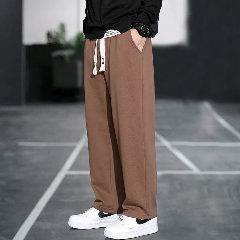 Men's grey casual trousers with multiple pockets showing high waist design and full length