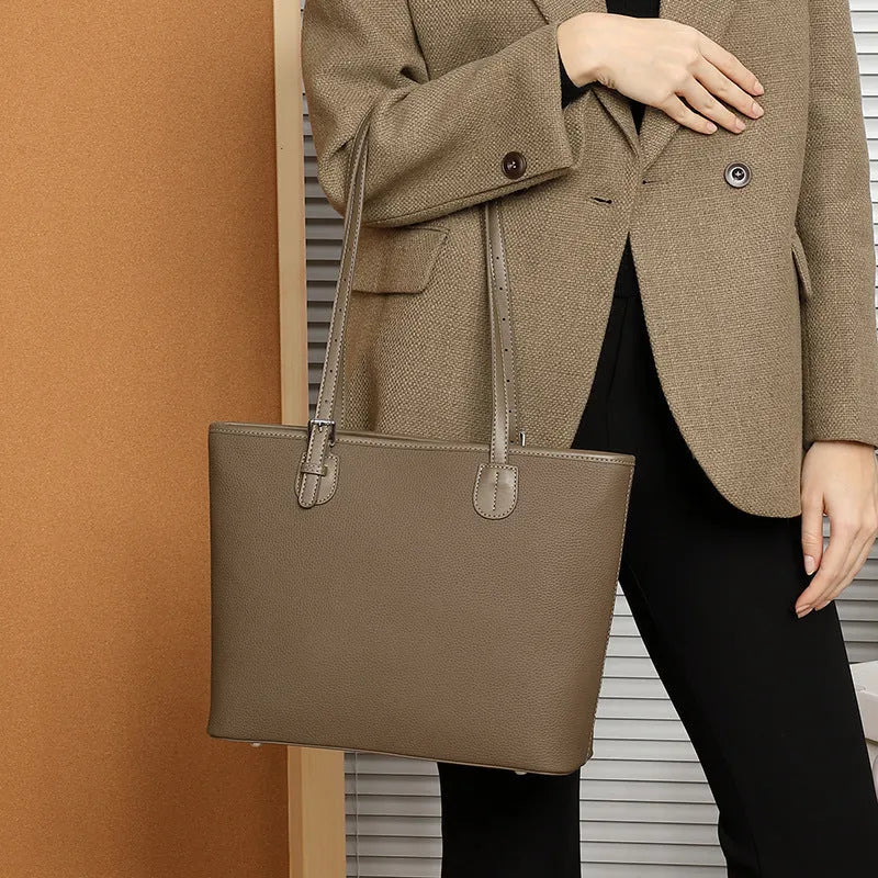 Women's genuine leather tote bag 30cm wide in black colour showing internal zipper compartments and retro styling