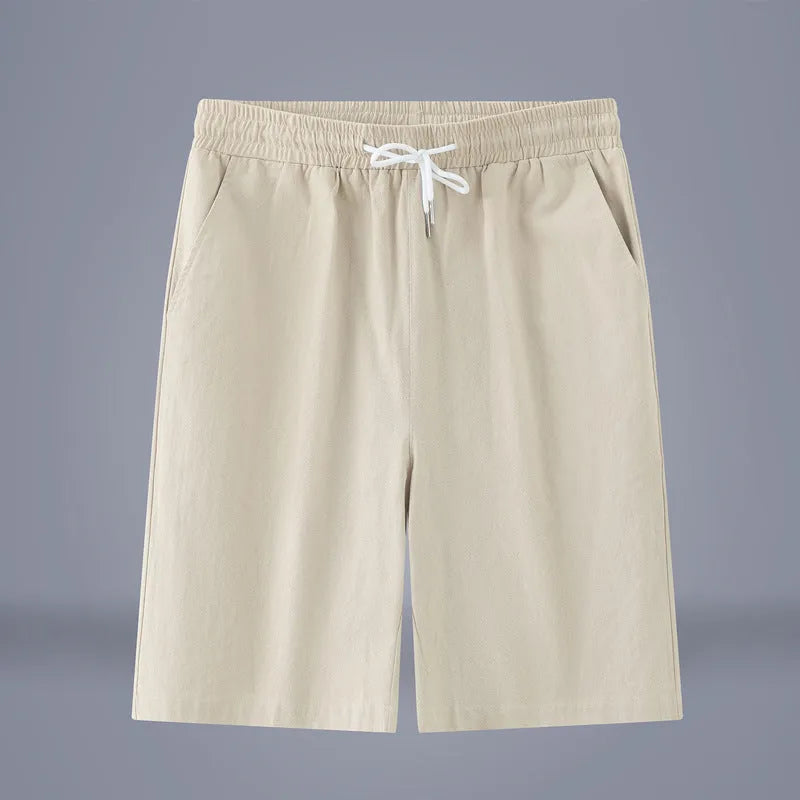 Solid colour cotton-linen cropped trousers with a drawstring waist on a hanger.