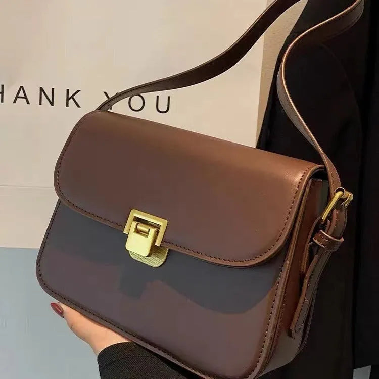 Soft black PU leather women's square cross-body bag with textured finish shown on model.
