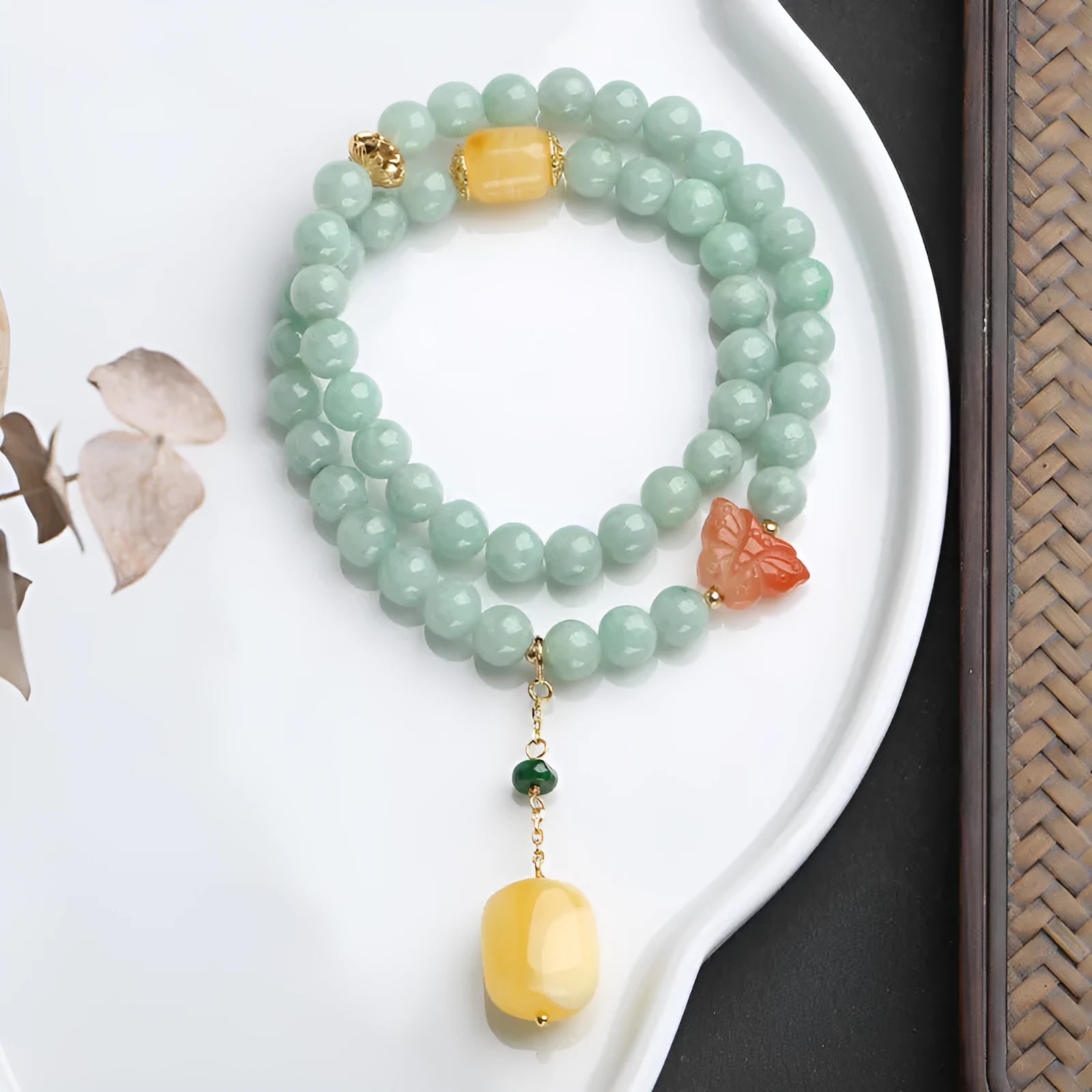 Double-layer retro bracelet with emerald jade round beads and hanging beeswax barrel beads.