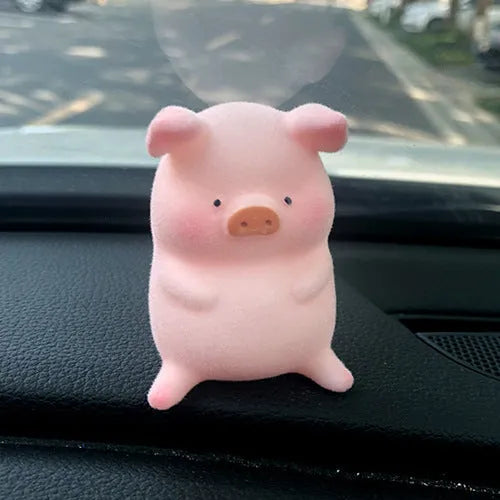 Set of eight cute cartoon pig resin car dashboard decorations on a car console