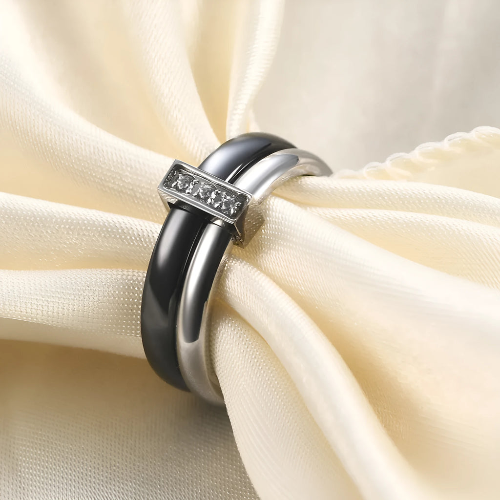 Geometric ceramic women's ring with glossy stitching and inlaid zirconium detail, shown in steel black.