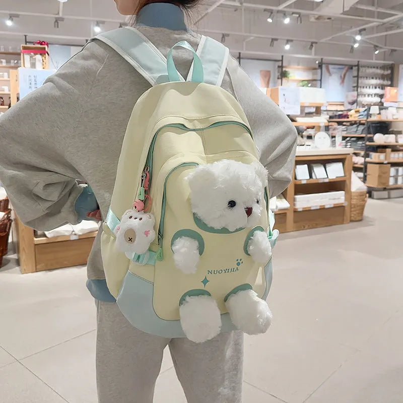 Nylon school backpack in a macaron colour with curved shoulder straps and sewing line detail.