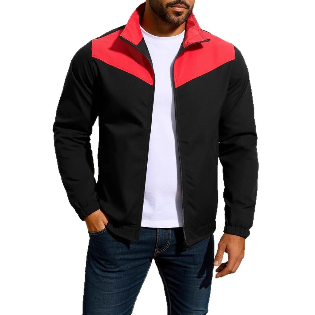 Man wearing a green windproof jacket with a high collar and colour-matched front zipper.