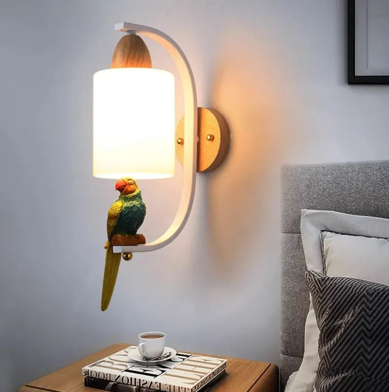 Resin bird wall lamp with iron body, wood accent, and glass lampshade on a wall