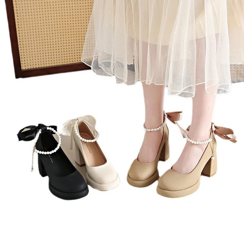 Beige women's Mary Jane shoes with chunky heel, ankle strap, pearl detail, and round toe.