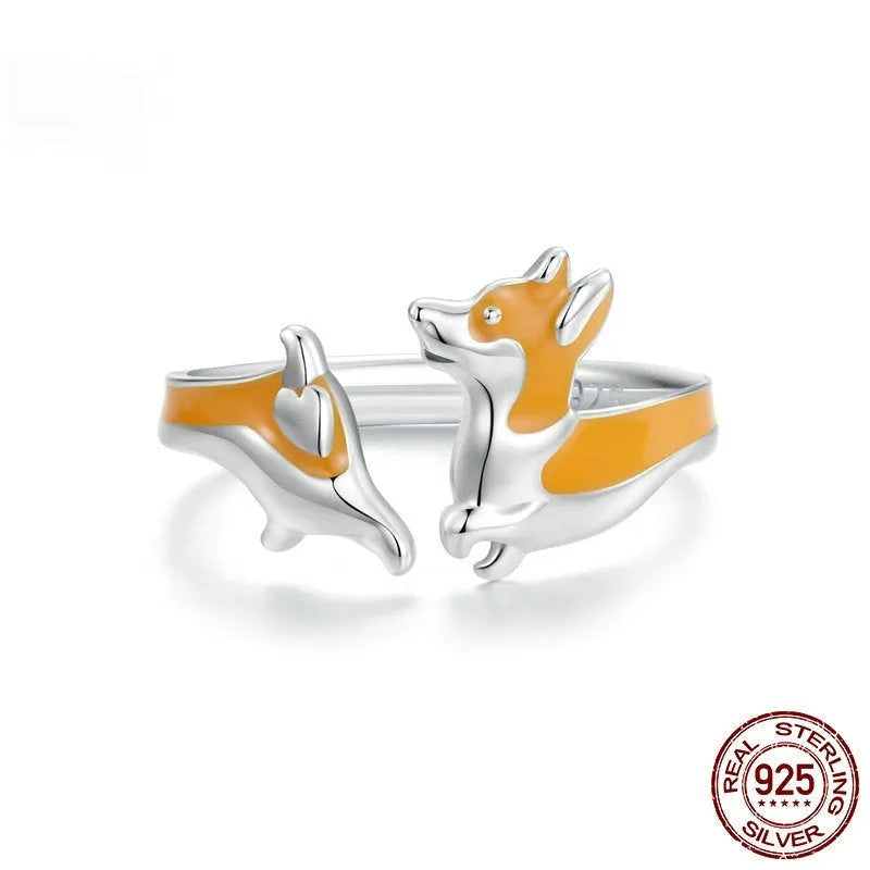 Silver-coloured adjustable ring featuring a raised cartoon corgi dog design, model SCR1014-E.