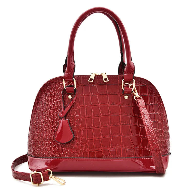 Women's shiny PU leather crossbody shoulder bag showing black, brown, and red colour options with 22x30x15cm dimensions