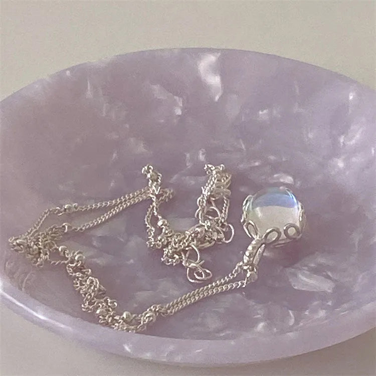 Round geometric 925 silver ornamental stone pendant on a silver curb chain necklace for women.