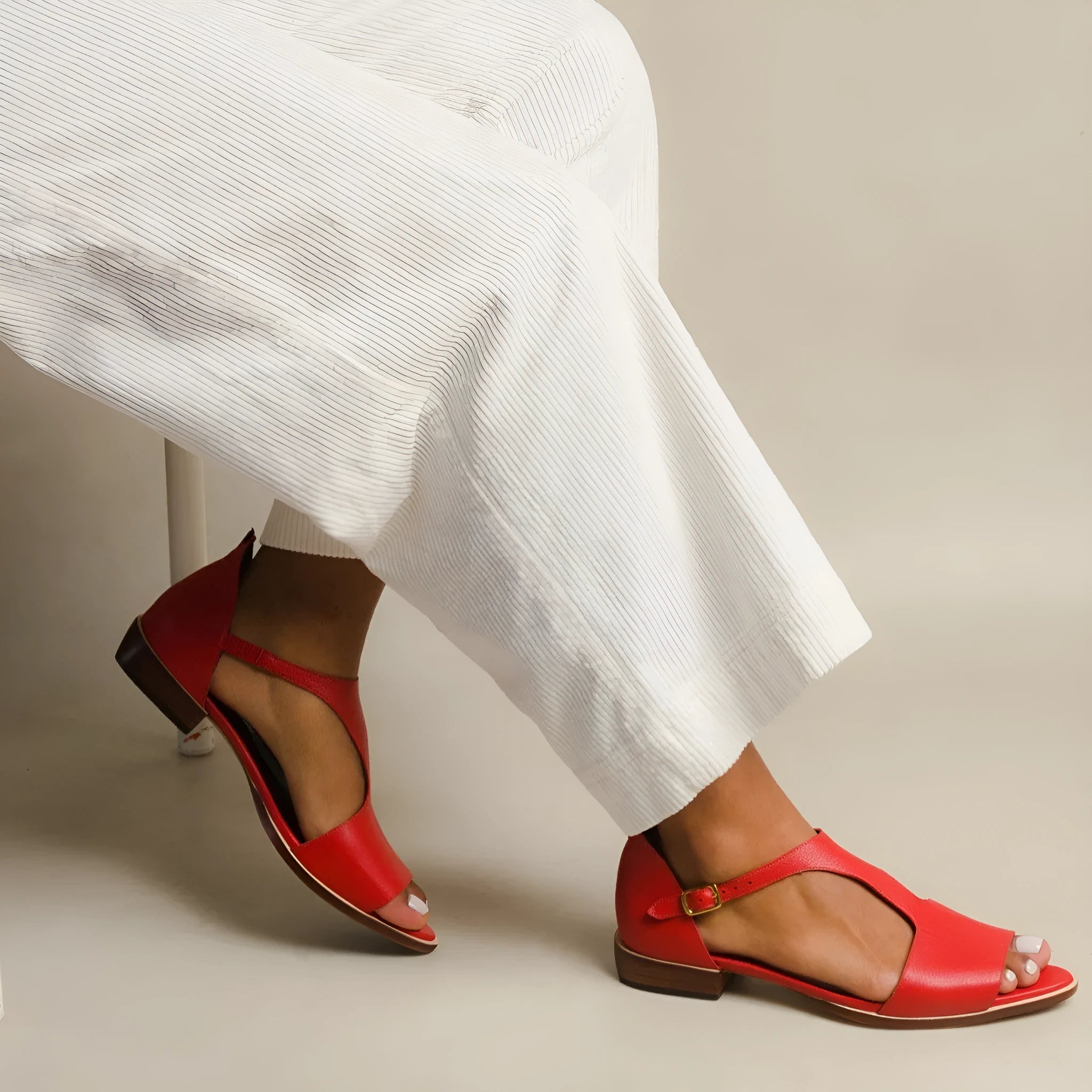 Red women's sandals with square buckle strap and herringbone toe holder design