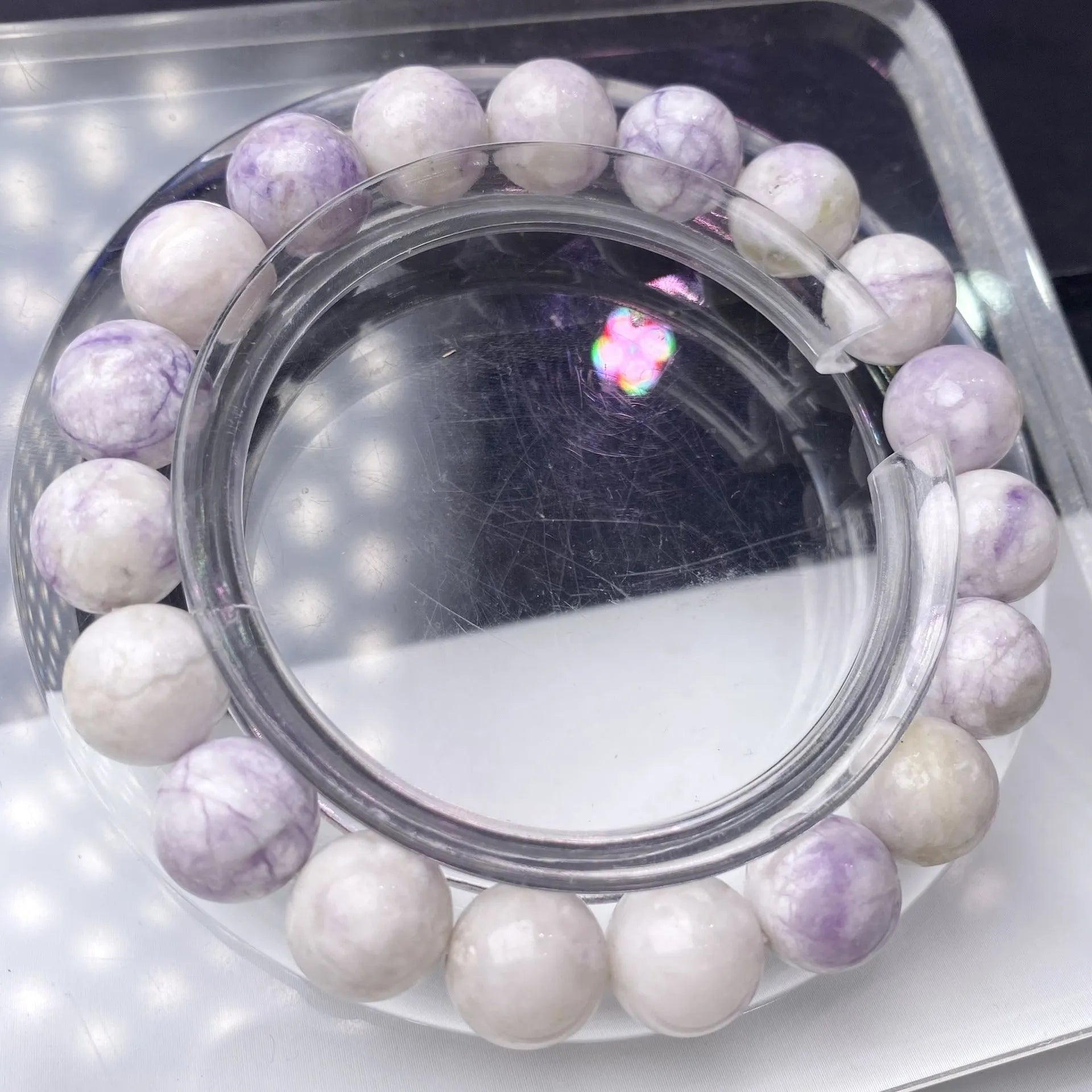 A purple turquoise bead bracelet for women showing round stone beads on a wrist.