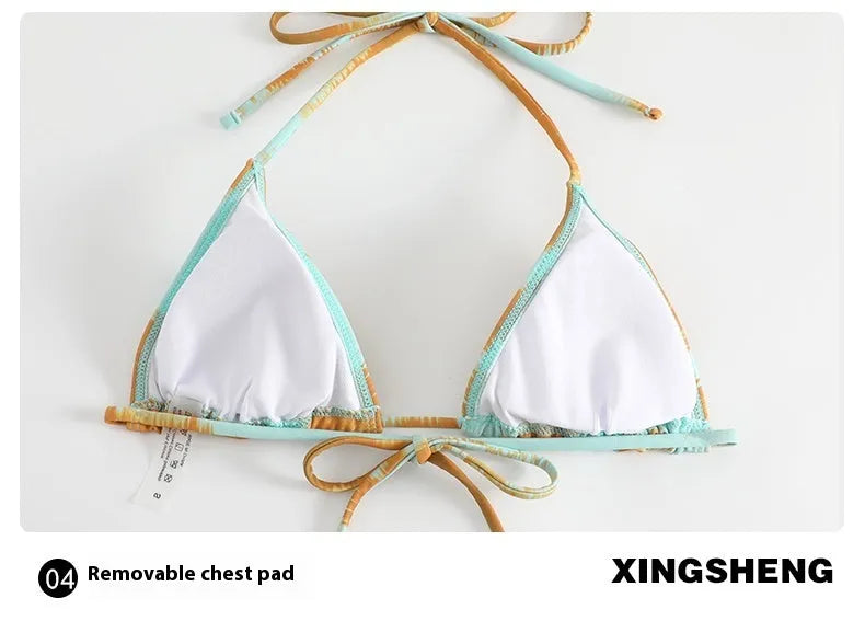 Women's green gathered tulle long-sleeved bikini top and skirt swimsuit set on a hanger