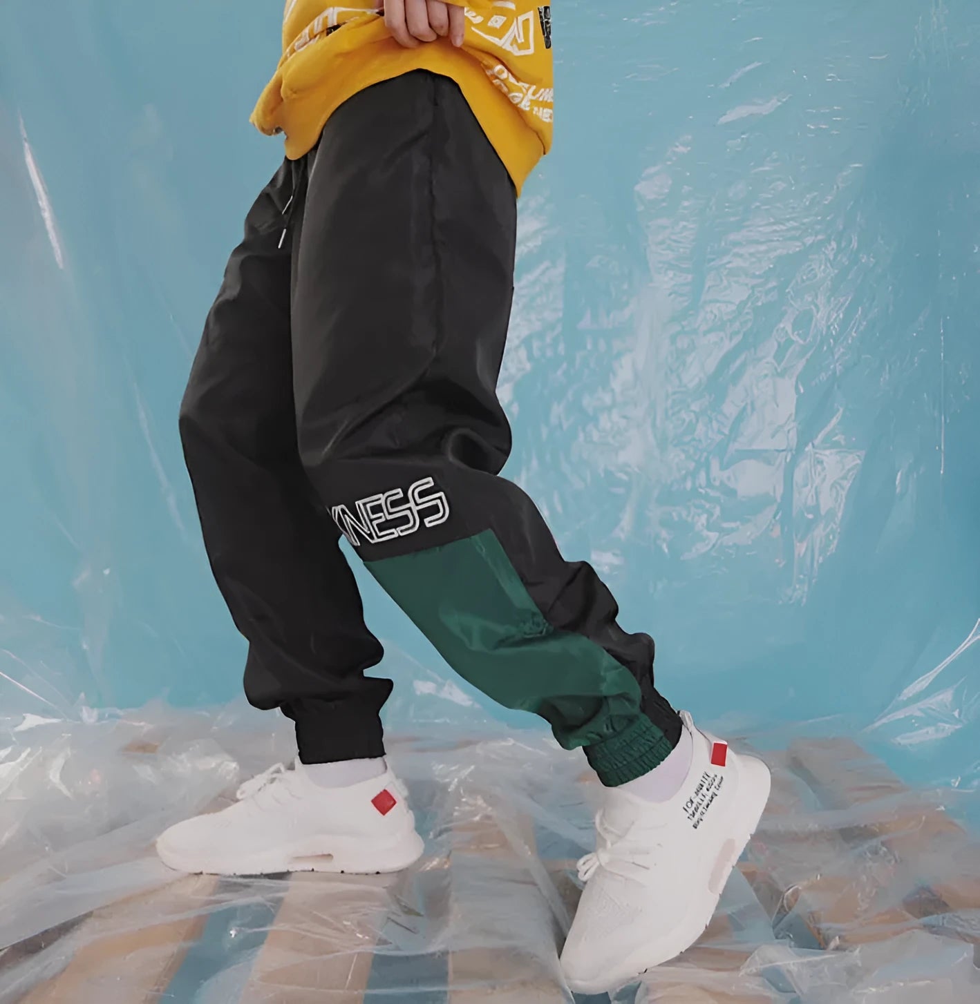 Green Japanese hip hop sweatpants with hit colour stitching, letter print, and bouquet floral design on a low-waist drawstring style