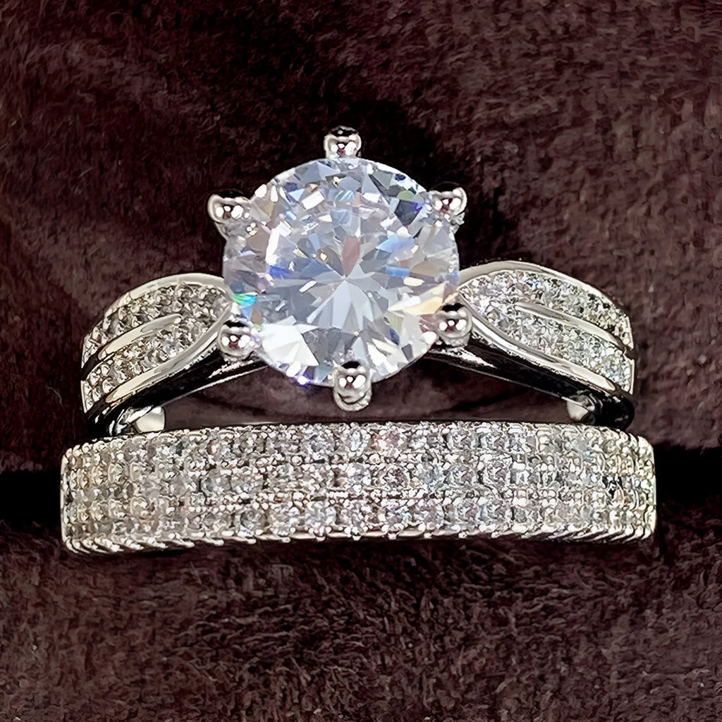 White gold colour alloy combined ring and bracelet with geometric shape and round details.