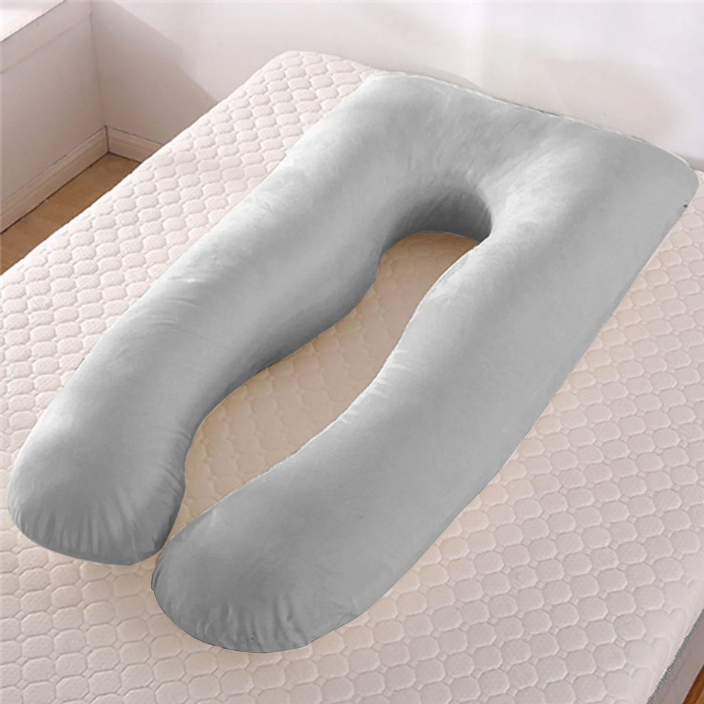U-shaped white maternity pillow with ice silk cover on a bed, showing its full-body support shape for pregnancy.