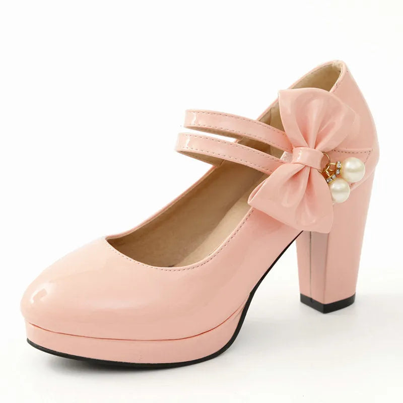 Red women's chunky heel platform shoes with a round toe and buckle fastening on a rubber sole.