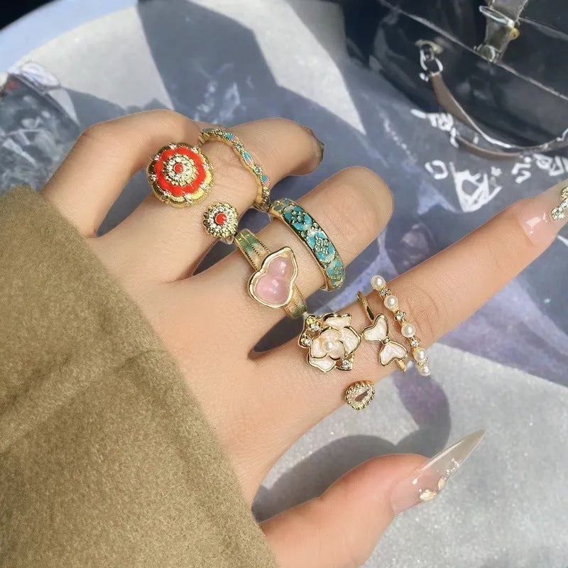 Adjustable vintage-style copper ring with inlaid zircon stones, featuring gourd, flower, and bow shapes.